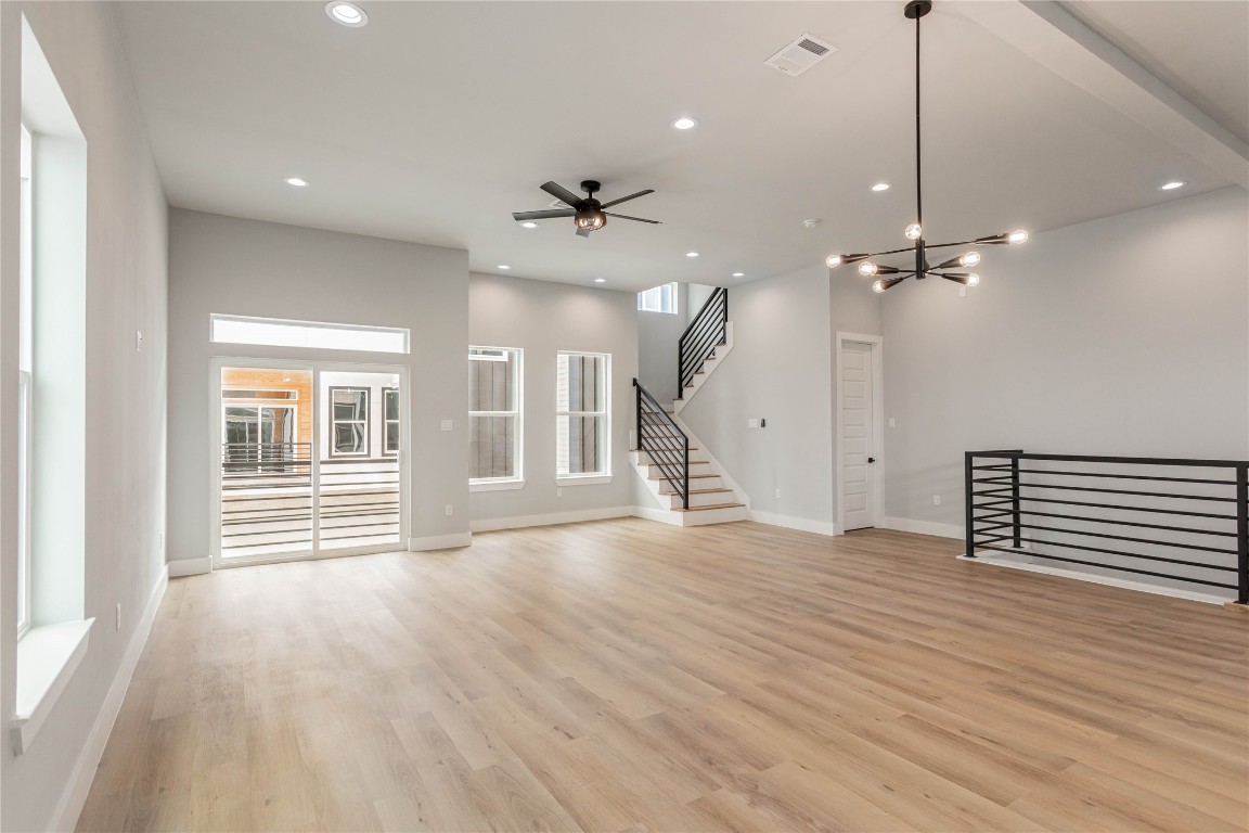 711 Boundary Street Houston, TX 77009 - Photo 8 of 26 an empty room with wooden floor fan and windows