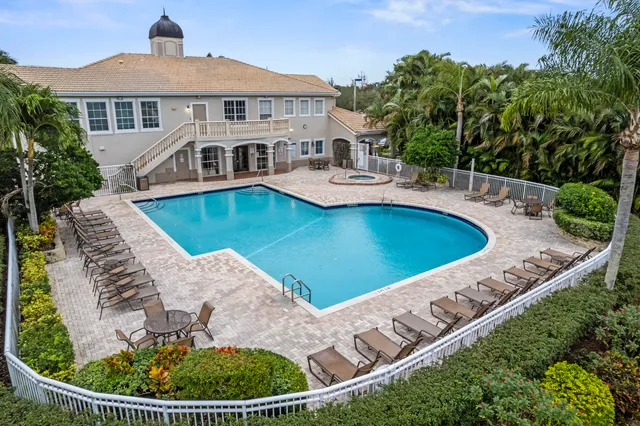 an aerial view of a house with swimming pool and mountain view