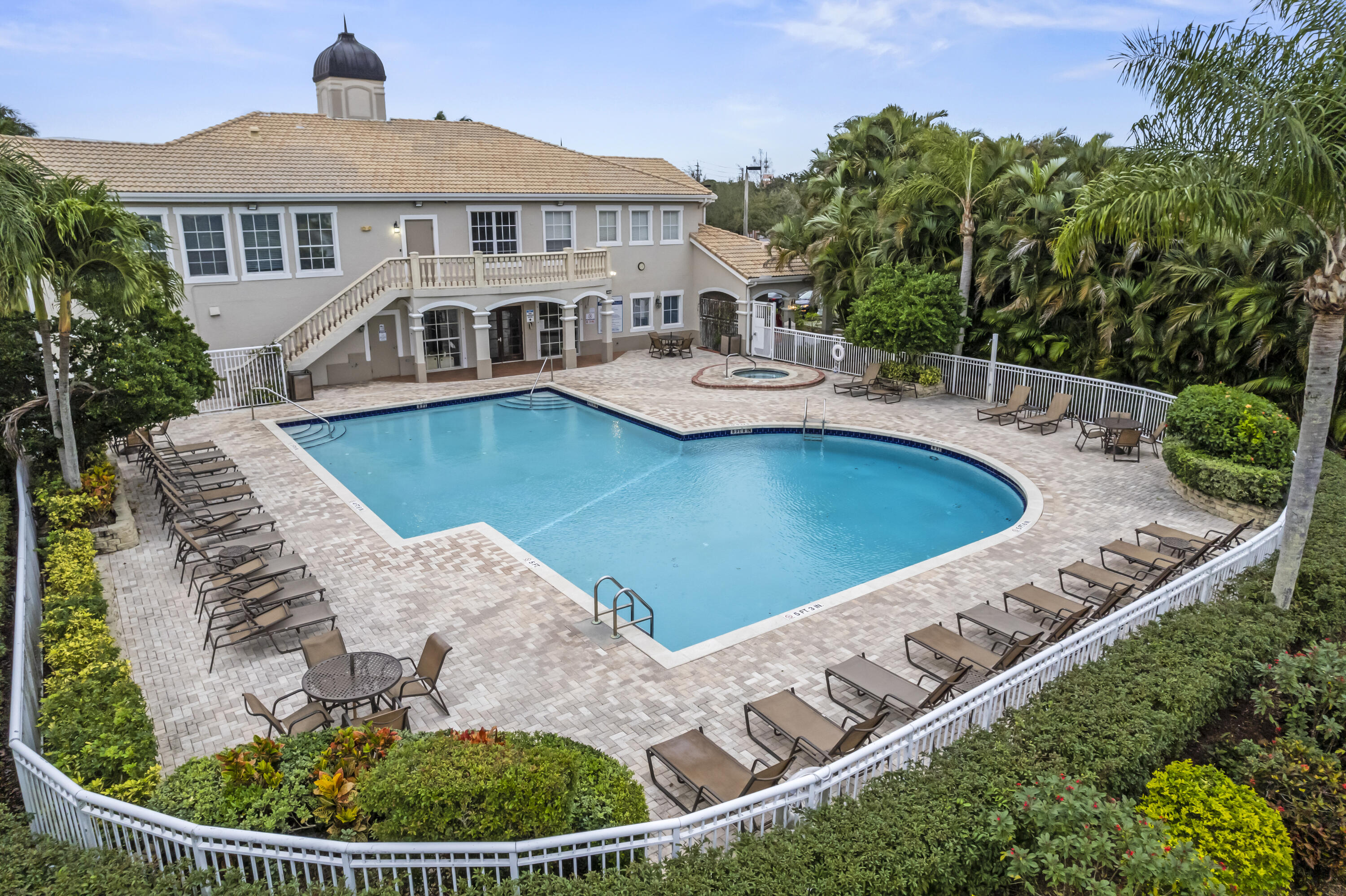 112 Southwest Peacock Boulevard, Unit 7202 Port St. Lucie, FL 34986 - Photo 1 of 11 an aerial view of a house with swimming pool and mountain view