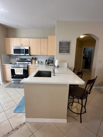 a kitchen with a sink a counter top space and appliances