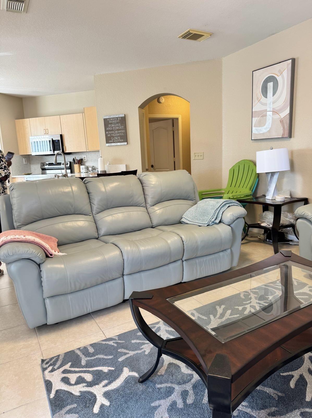112 Southwest Peacock Boulevard, Unit 7202 Port St. Lucie, FL 34986 - Photo 6 of 11 a living room with furniture and wooden floor
