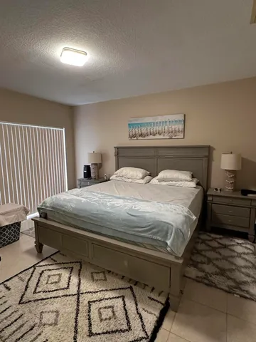 a bedroom with a bed and a night stand