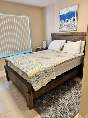 a bedroom with washing machine and wooden floor