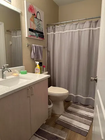 a bathroom with a sink toilet and shower