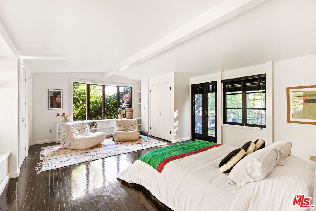 8577 Brier Drive Los Angeles, CA 90046 - Photo 20 of 39 a bedroom with a bed and large windows