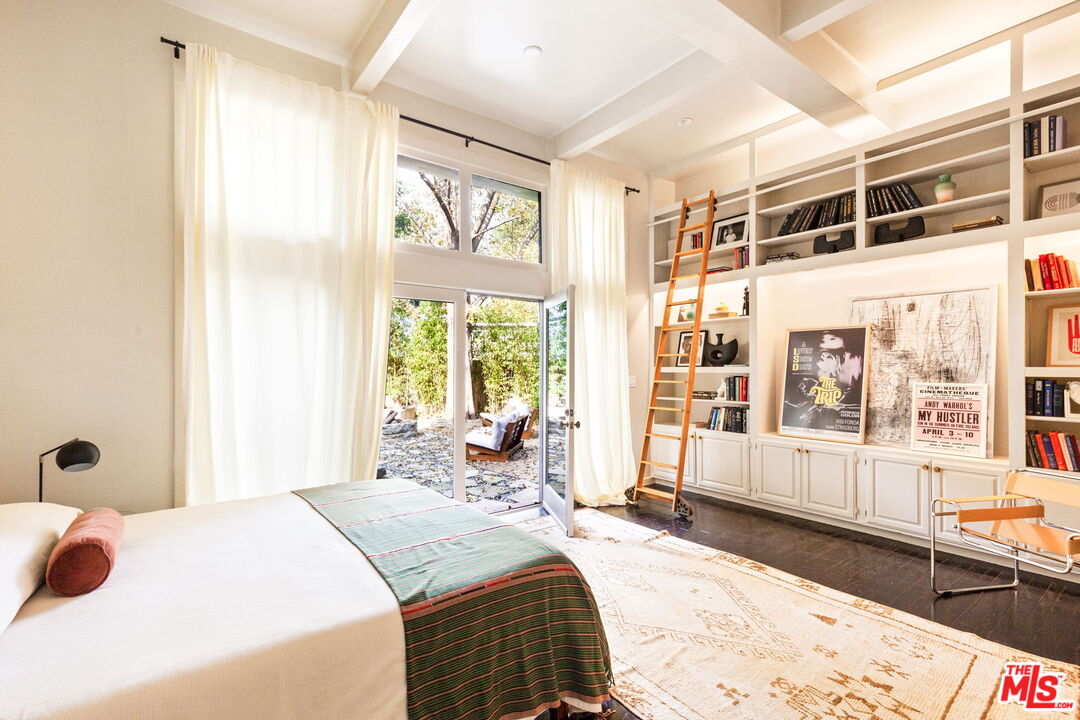 8577 Brier Drive Los Angeles, CA 90046 - Photo 25 of 39 a bedroom with a bed and wooden floor