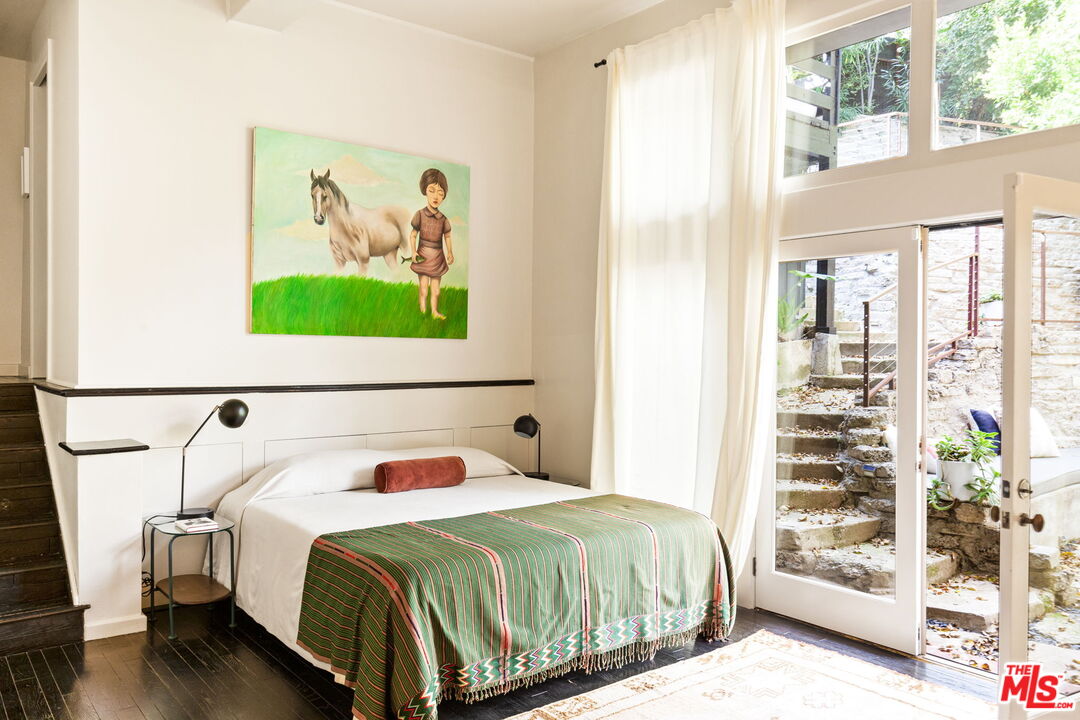 8577 Brier Drive Los Angeles, CA 90046 - Photo 28 of 39 a bedroom with a bed and a painting on the wall