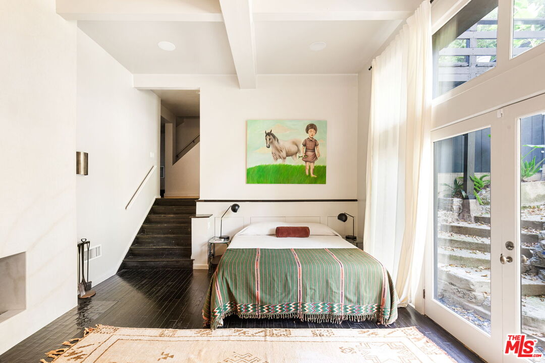 8577 Brier Drive Los Angeles, CA 90046 - Photo 29 of 39 a bedroom with a bed and a large mirror