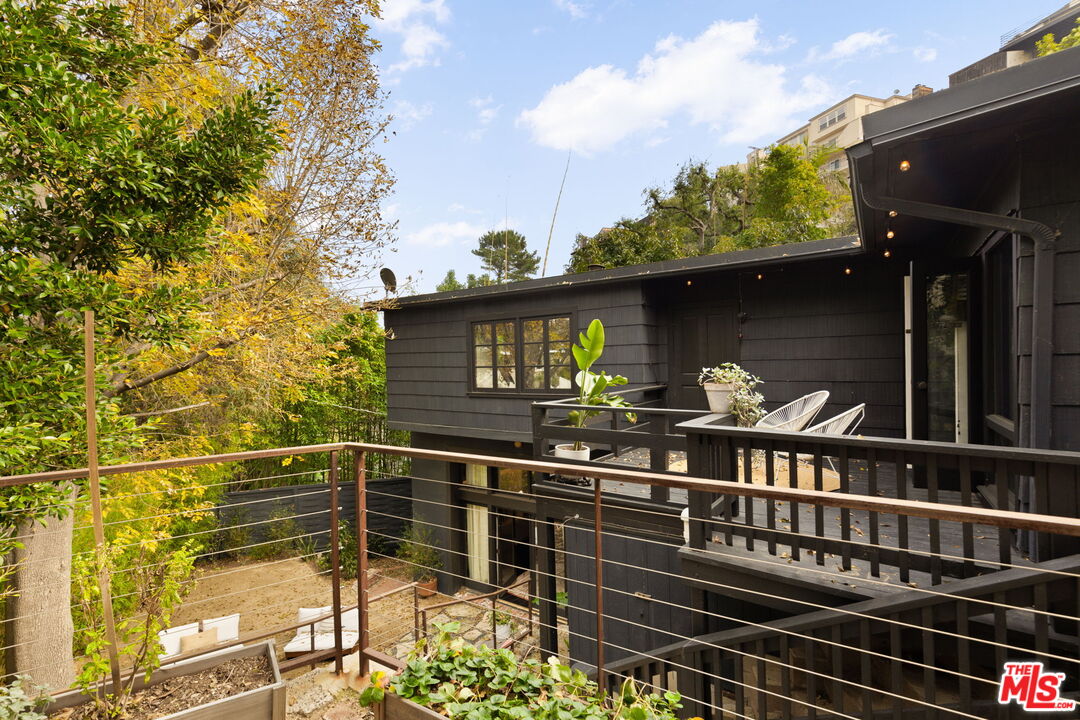 8577 Brier Drive Los Angeles, CA 90046 - Photo 36 of 39 a view of a roof deck with couches and wooden floor