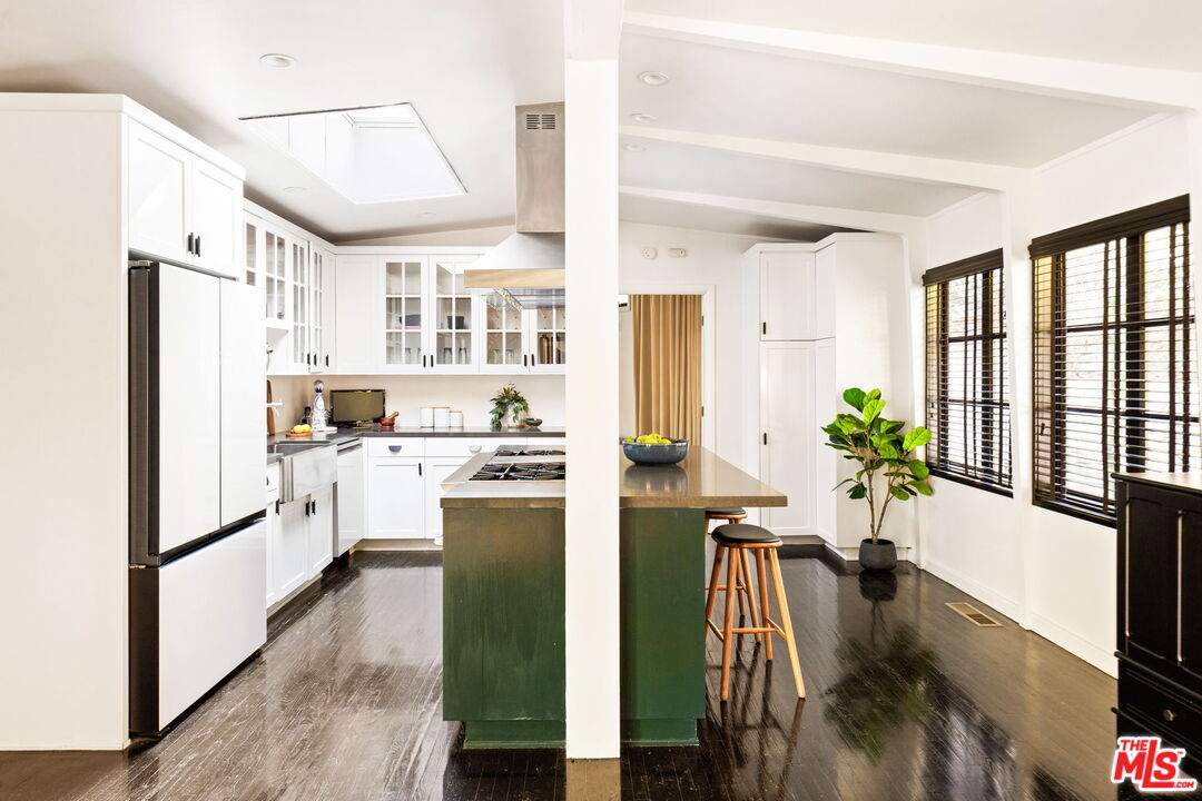 8577 Brier Drive Los Angeles, CA 90046 - Photo 7 of 39 a kitchen with stainless steel appliances a refrigerator a oven a sink a dining table and chairs