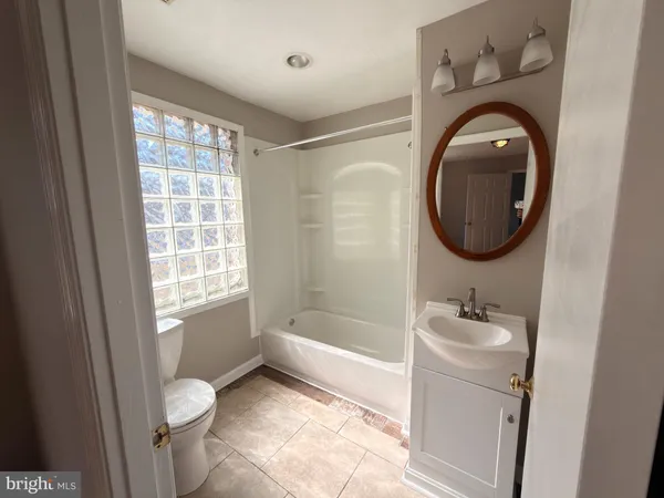 a bathroom with a sink a toilet and a tub