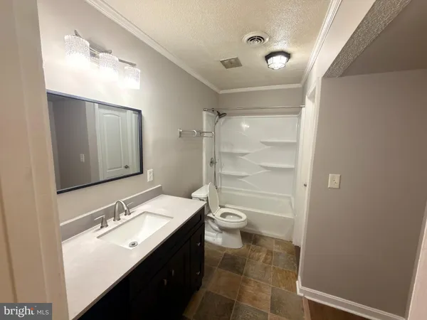 a bathroom with a sink shower and a toilet