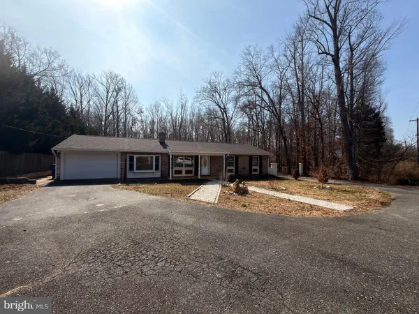 a view of a large house with a large yard and a large tree