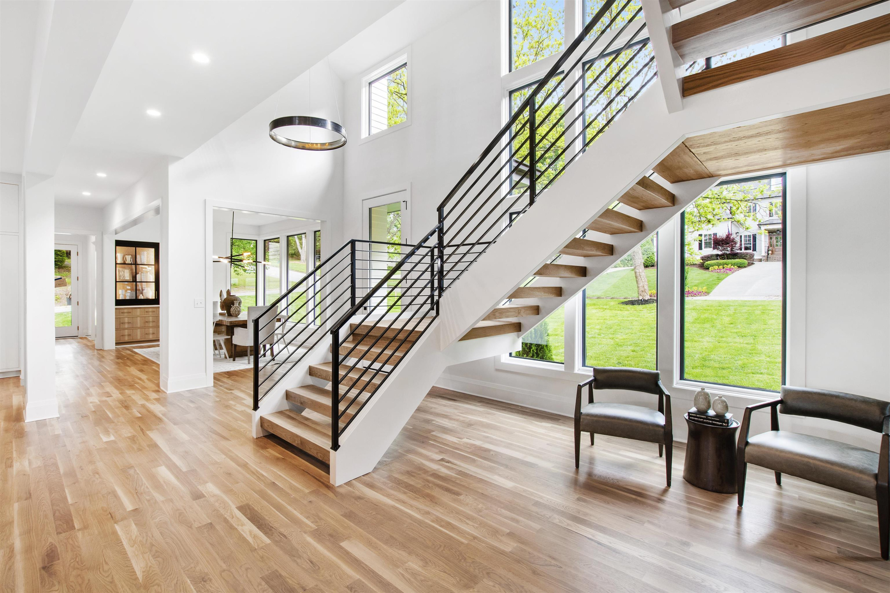 3340 Hampton Road Raleigh, NC 27607 - Photo 10 of 66 A floating staircase in front of a wall of windows is one of many focal points in this home. Staircase