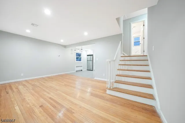 a view of a room with wooden floor and stairs