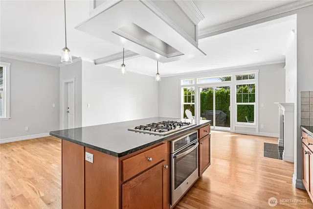 a kitchen that has a stove and a table in it