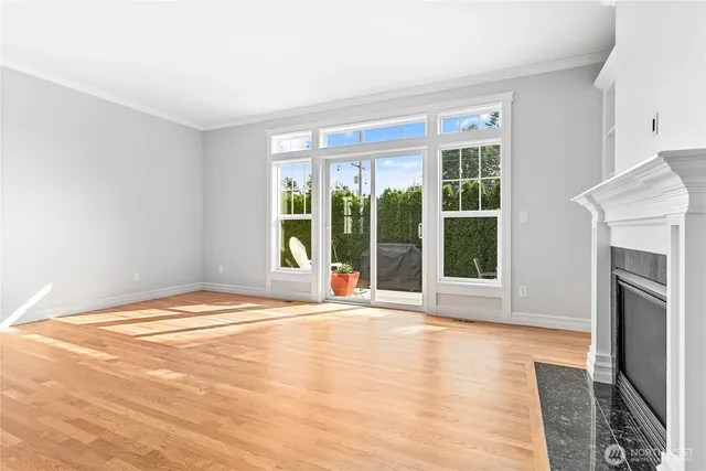 a view of an empty room with glass door and balcony