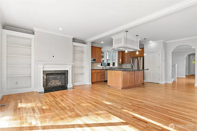 a view of a kitchen with a sink and a fireplace