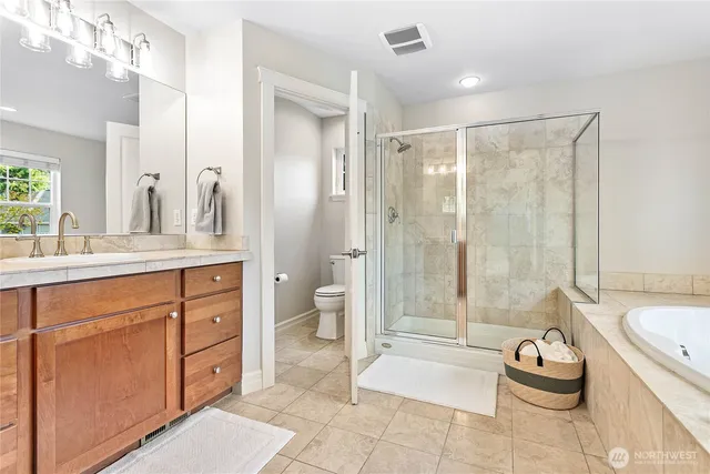 a bathroom with a bathtub shower sink and toilet