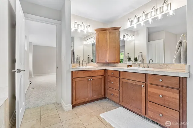 a spacious bathroom with a double vanity sink mirror and