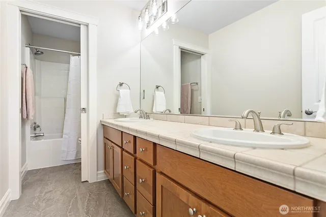 a bathroom with a double vanity sink and a mirror