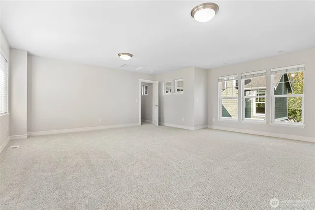 an empty room with windows and entrance