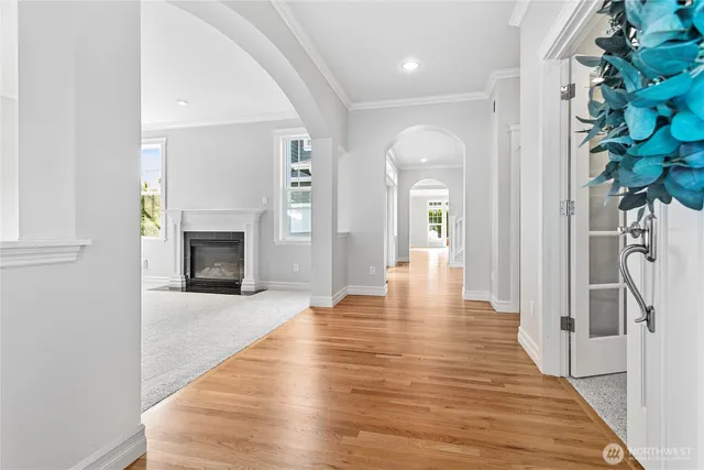 a view of a hallway with wooden floor and a fireplace