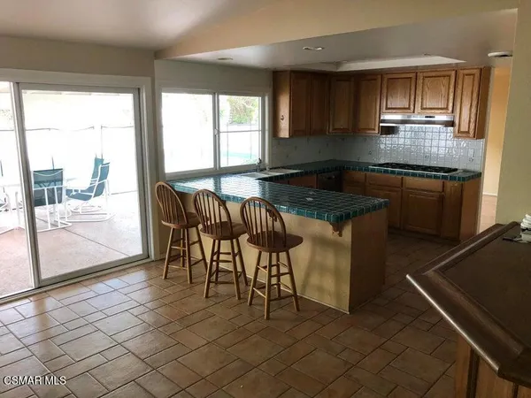 a kitchen with granite countertop a stove a sink and a granite counter top