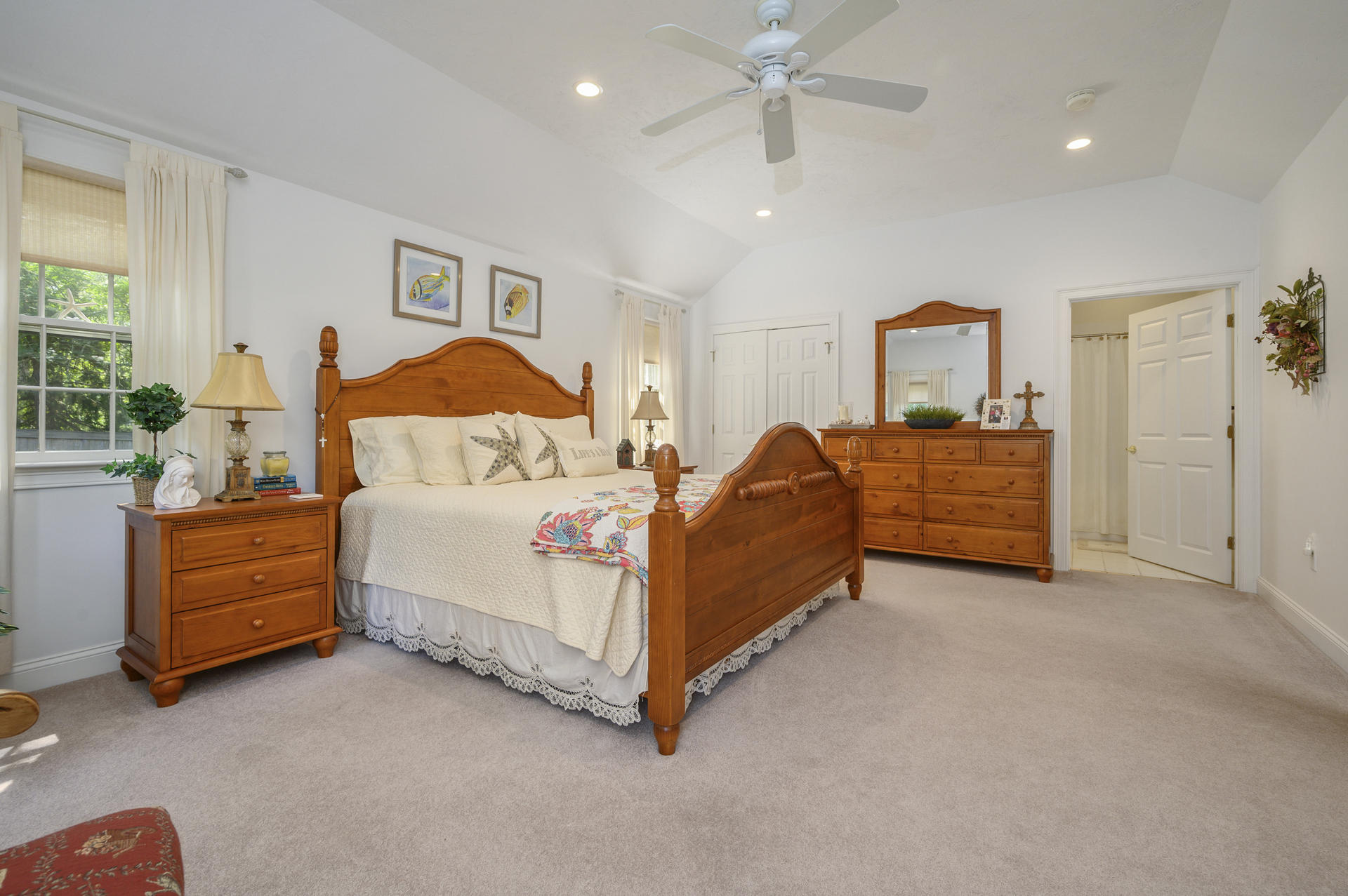 63 Fuller Road Centerville, MA 02632 - Photo 11 of 17 a spacious bedroom with a bed and a chandelier
