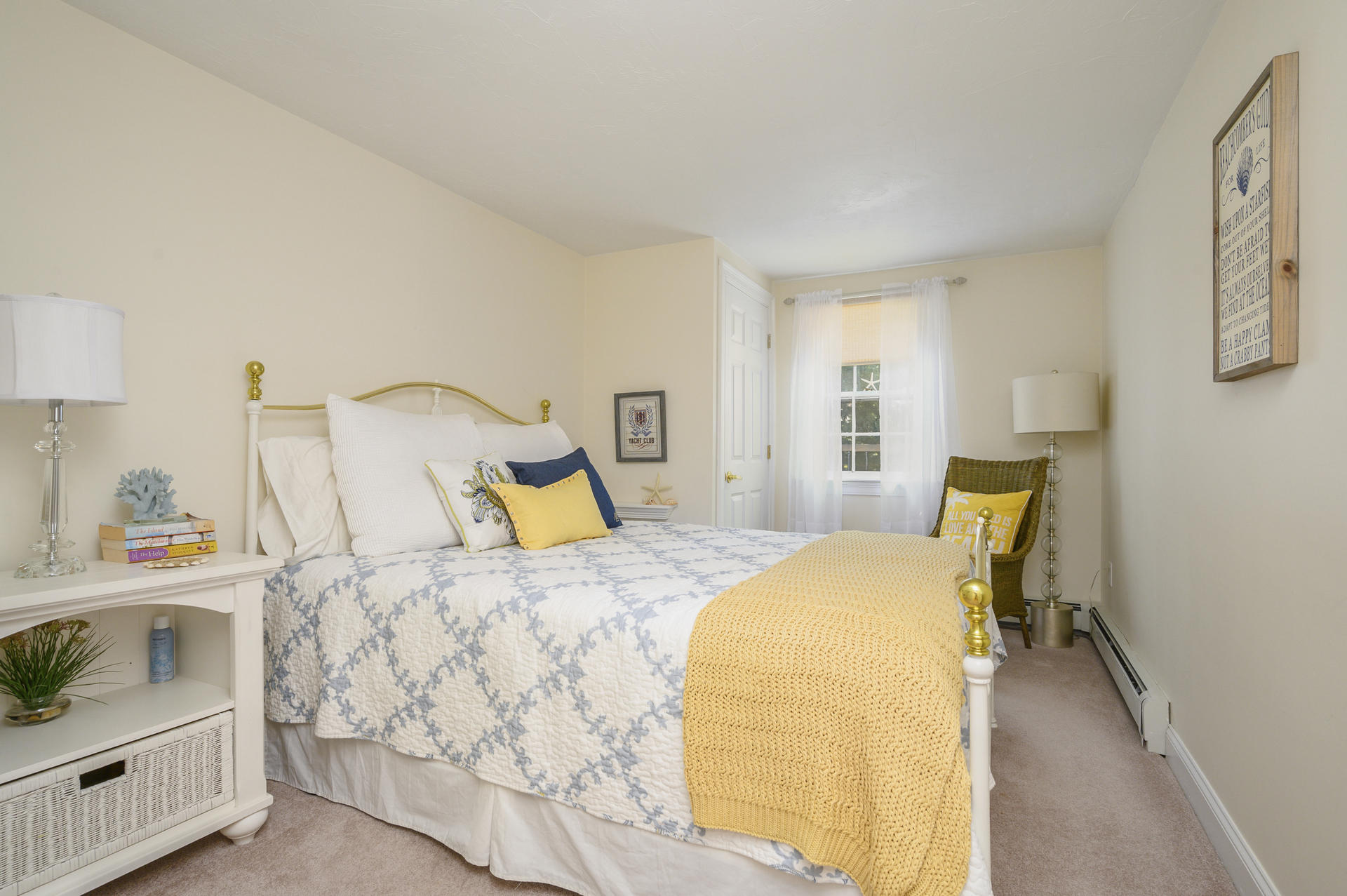 63 Fuller Road Centerville, MA 02632 - Photo 13 of 17 a bed sitting in a bedroom next to a window with dresser and lamp
