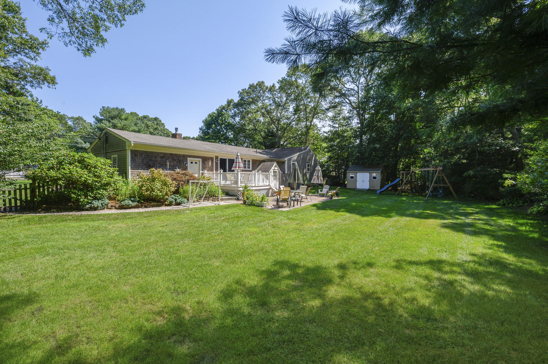 63 Fuller Road Centerville, MA 02632 - Photo 17 of 17 a view of house in front of a big yard with large trees
