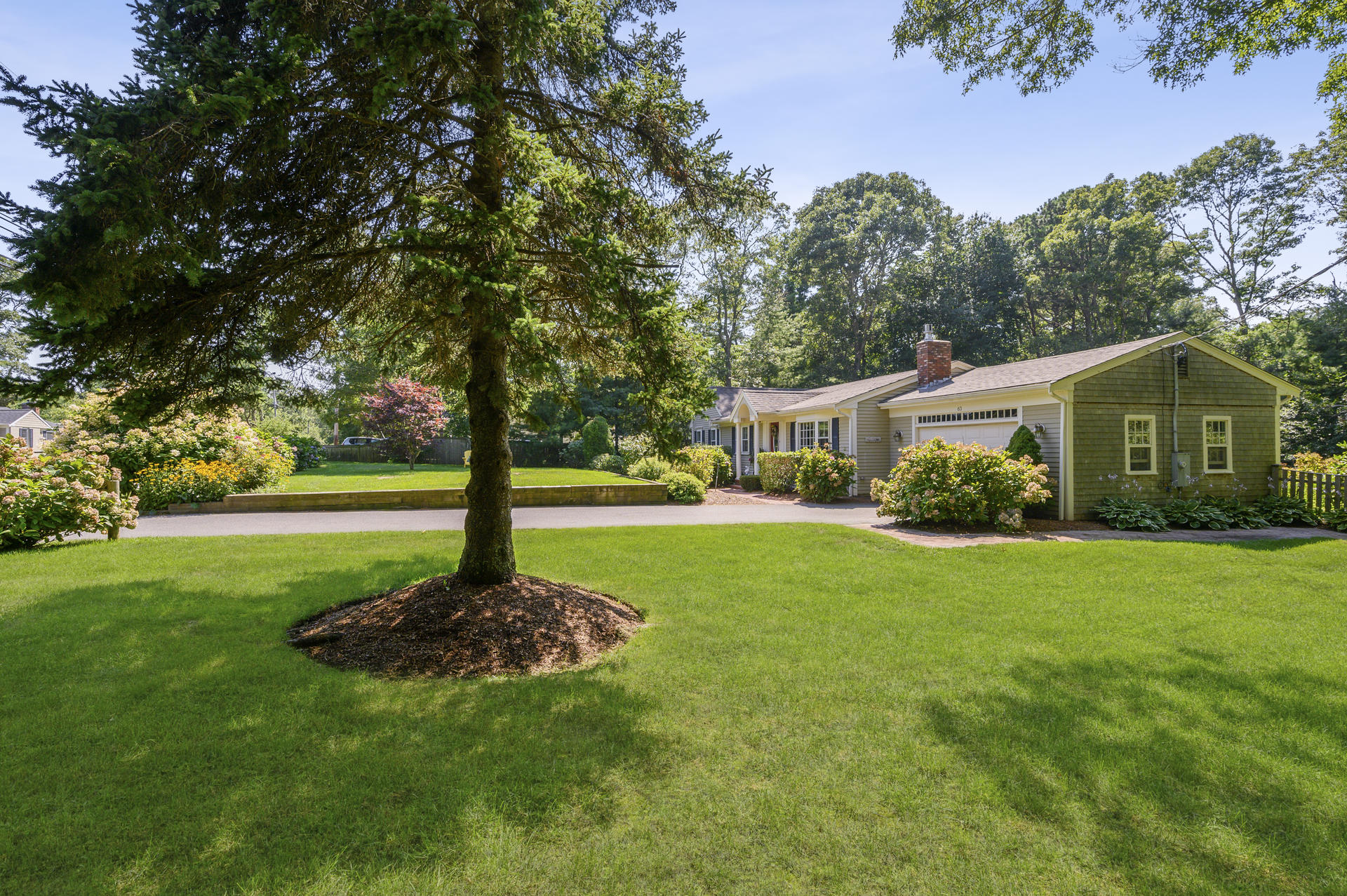 63 Fuller Road Centerville, MA 02632 - Photo 3 of 17 a house view with a garden space