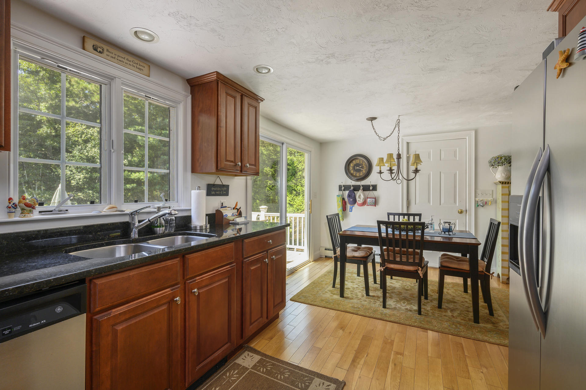 63 Fuller Road Centerville, MA 02632 - Photo 8 of 17 a kitchen with stainless steel appliances granite countertop sink stove top oven table and chairs