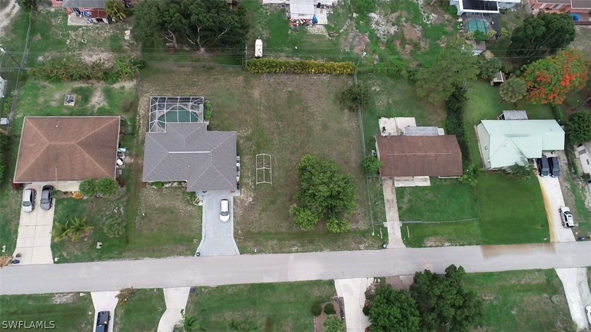 19140 Coconut Road Fort Myers, FL 33967 - Photo 6 of 6 an aerial view of a house with outdoor space lake view and trees all around