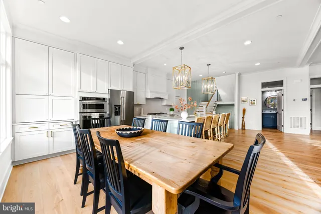 a living room with fireplace furniture and a large window