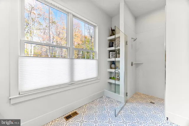 a spacious bathroom with double sink and mirror
