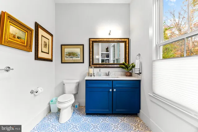 a bathroom with a sink a tub and a large mirror