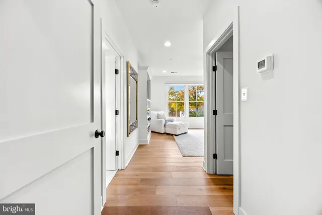 a bedroom with a bed lamps and wooden floor