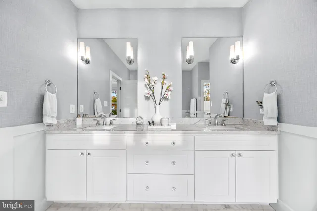 a bathroom with a sink vanity and toilet
