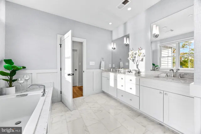 a view of entryway with paintings on the walls