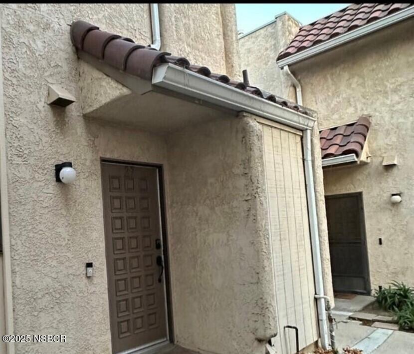 a view of a balcony with furniture and shower