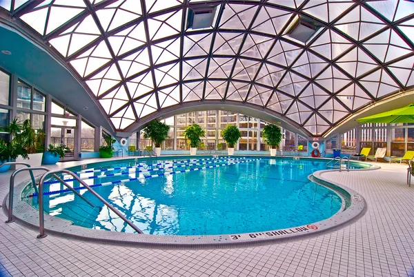 a view of a swimming pool with a patio and a yard