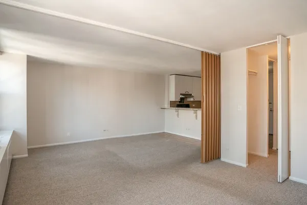 a view of a kitchen cabinets and an empty room