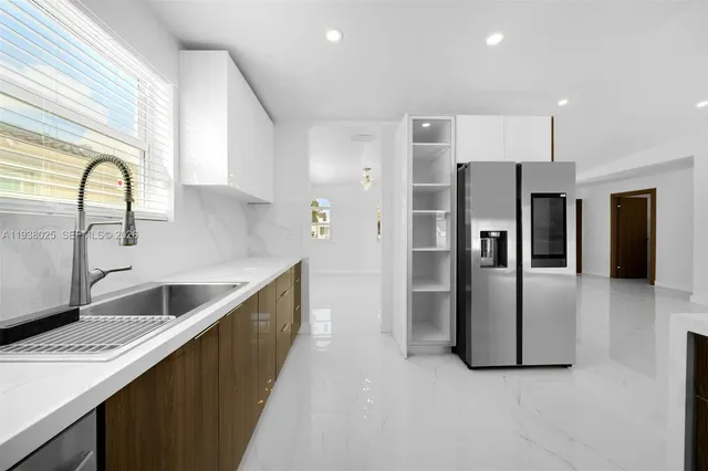 a kitchen with refrigerator and cabinets