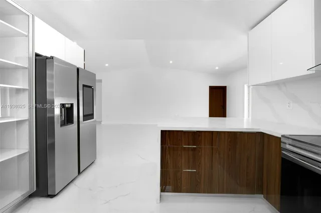 a kitchen with stainless steel appliances a refrigerator and a sink