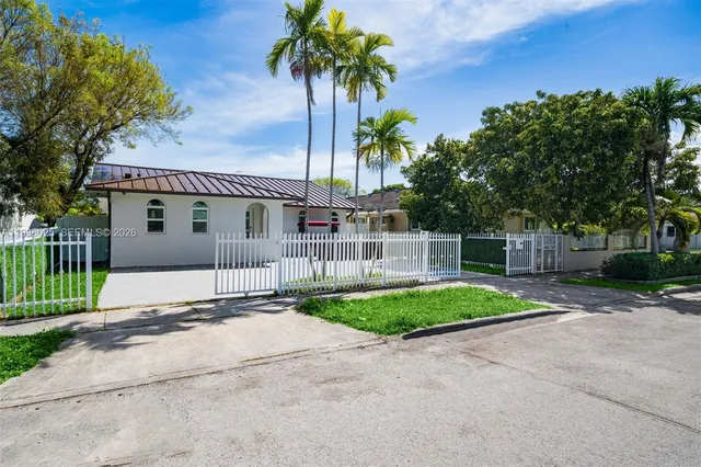 a house with palm tree in front of it
