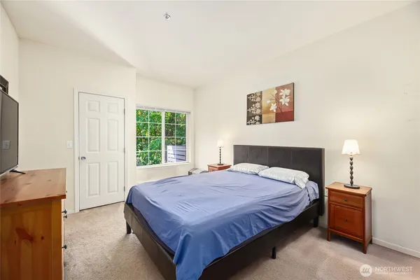 a bedroom with a bed and a window