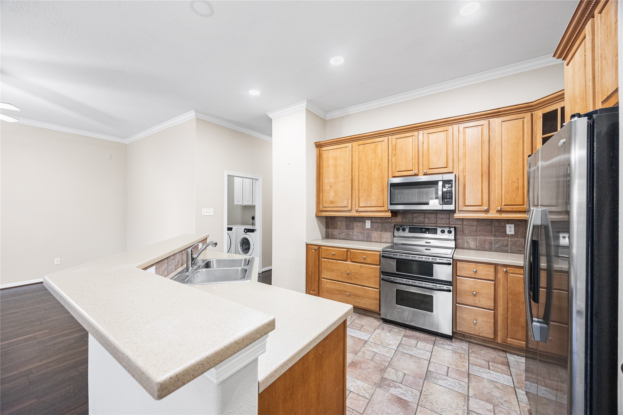 12755 Mill Ridge Drive, Unit 703 Cypress, TX 77429 - Photo 12 of 31 a kitchen with stainless steel appliances a stove microwave and refrigerator