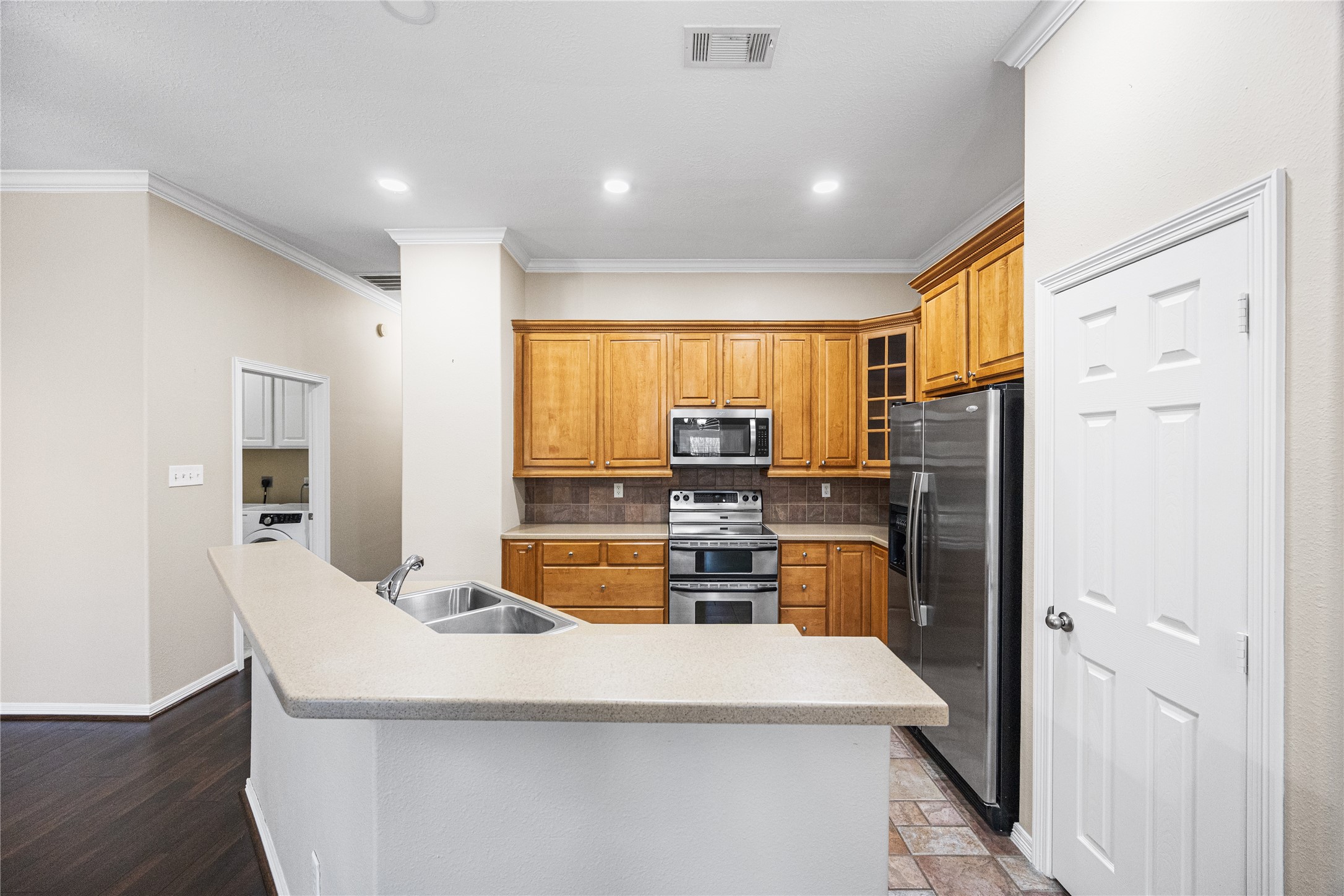 12755 Mill Ridge Drive, Unit 703 Cypress, TX 77429 - Photo 13 of 31 a kitchen with a refrigerator and a stove top oven