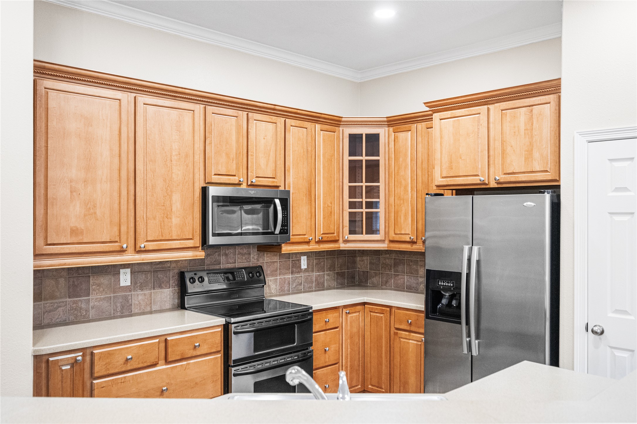 12755 Mill Ridge Drive, Unit 703 Cypress, TX 77429 - Photo 14 of 31 a kitchen with stainless steel appliances granite countertop a refrigerator stove top oven and sink